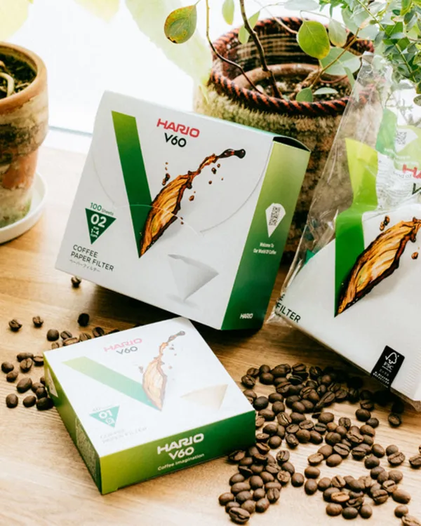 Boxes of V60 paper filters with coffee beans